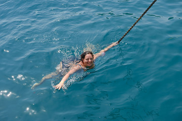 High angle view of young woman swimming in the sea.