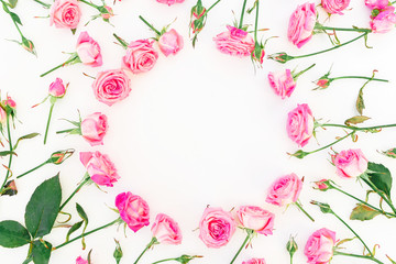Floral round frame made of pink roses, branches and leaves on white background. Valentines day. Flat lay, Top view.