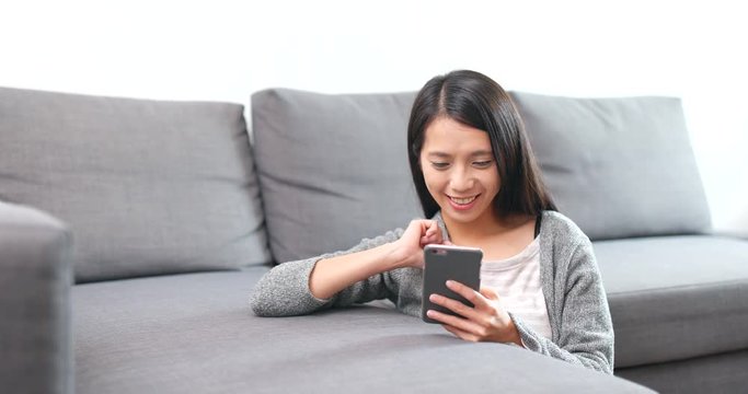 Woman playing the game on cellphone and being the winner at the end