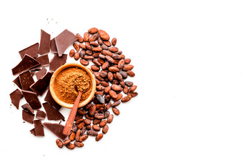 Make chocolate. Cocoa powder in bowl near cocoa beans and pieces of chocolate on white background top view copy space