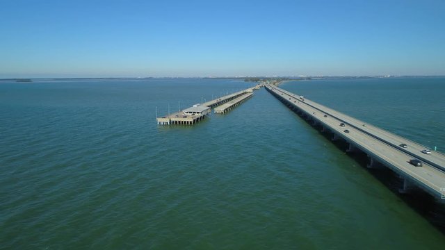 Aerial drone video Sunshine Skyway Bridge fishing pier Tampa Bay 4k 24p