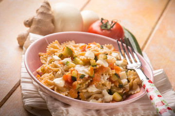 pasta with tomatoes zucchinis and scamorza cheese, selective focus