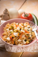pasta with tomatoes zucchinis and scamorza cheese, selective focus