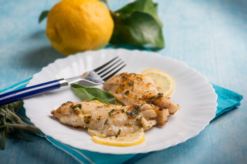 fish fillet with lemon and sage, selective focus