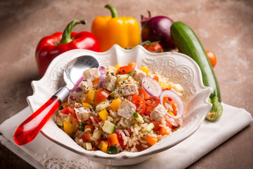 rice salad with fish and mixed vegetables, selective focus