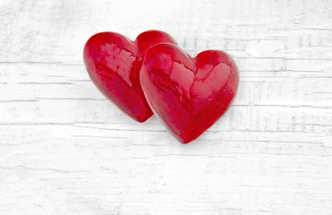 Two luxury red hearts on white wooden background. Happy Valentines day.