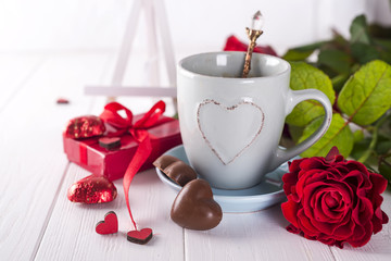 Red rose, coffee cup and gift box