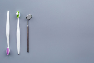 Clean teeth. Brushes on blue background top view copy space