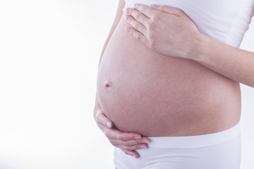 The picture of baby bump isolated on white background. The happiness of waiting for a new family member.