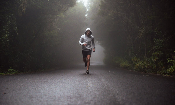 Portrait Of A Young Athlete Running On The Road