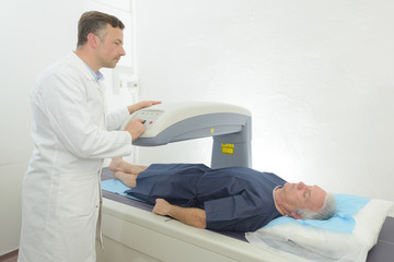 patient on a scan machine in hospital room