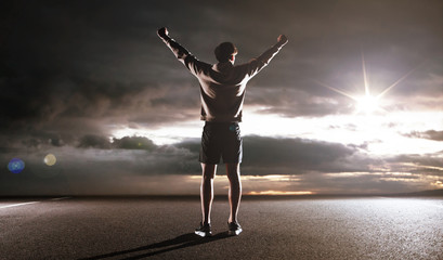 Fototapeta na wymiar Portrait of an athlete looking at the dark clouds