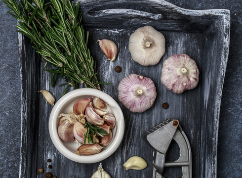 Fresh garlic with rosemary on wooden background. Garlic bulbs
