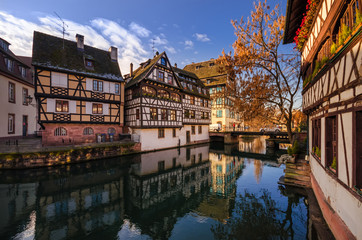 Fototapeta na wymiar Beautiful views of historic city of Strasbourg and river Ill. Traditional half-timbered houses in Alsace. France.