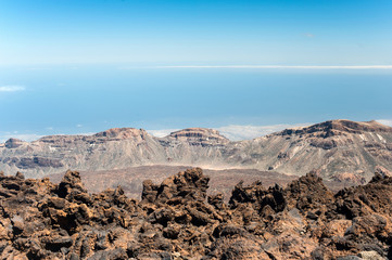 Crater of Pico Viejo volcano on a blue cloudscape background