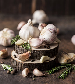 Fresh garlic with rosemary on wooden background. Garlic bulbs