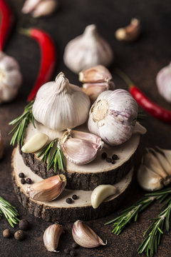 Fresh garlic with rosemary on wooden background. Garlic bulbs