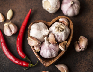 Fresh garlic with chili pepper on dark background. Garlic bulbs