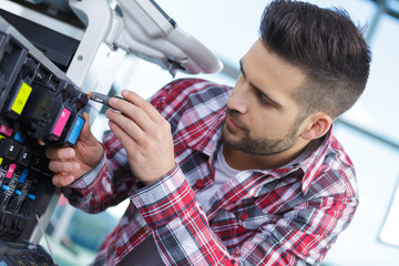 Fototapeta premium technician fixing photocopier machine