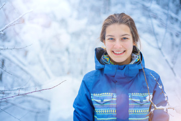 Beautiful young girl in winter park