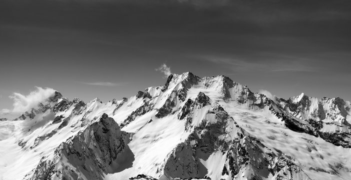 Black and white panoramic view of snow covered mountain peaks