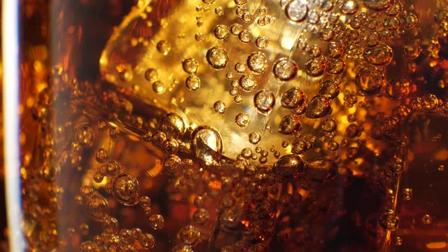 Cola with ice background. Large glass of cold coke with ice cubes close-up. 4k