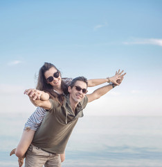 Conceptual portrait of a young, cheerful couple on vacation