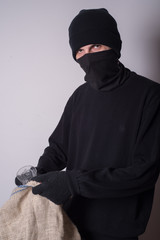 masked thief with bag 