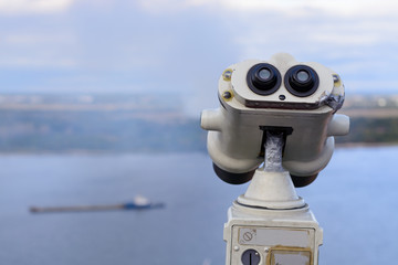Big binoculars on the observation deck on the banks of the Volga river