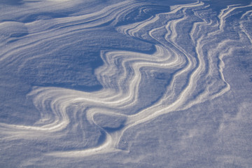 Abstract wind shapes in snow