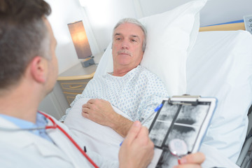 doctor and patient discussing xray in hospital room