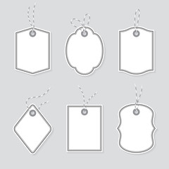 Blank price tags and gift cards tied up with baker twine bows and ribbons set. Paper labels of different shapes