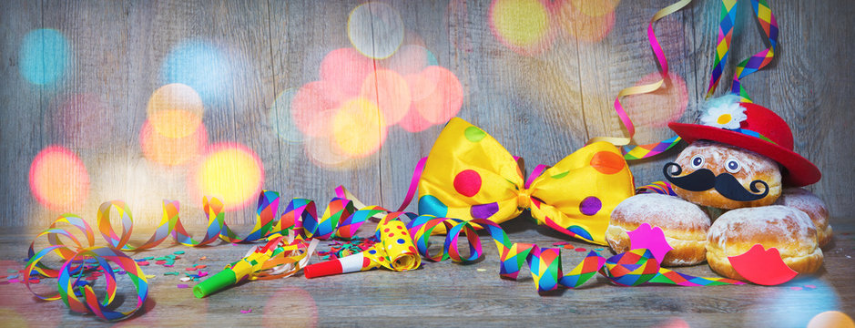 Carnival donuts with paper streamers and party bow tie