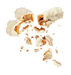 Waffle milk chocolate bar with nuts broken into two parts on white background