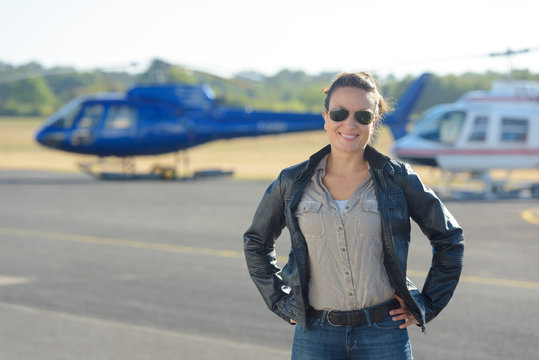 helicopter pilot posing on tarmac