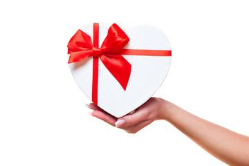 hand of a woman and with gift box red heart-shaped, isolated on white background. valentines day theme.