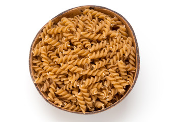 Uncooked wholemeal pasta isolated white background.