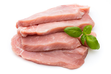 Fresh pork fillet with basil on a white background.