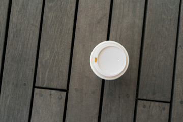 Top view of single hot latte on vintage wooden floor at relaxing balcony.