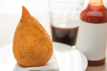 Coxinha is a deep fried food, traditional in Brazil. Snack, pepper sauce and coffee. bar food.