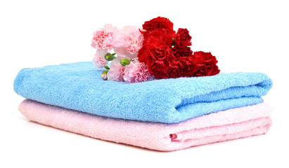 Stack of colorfull towels and carnation flower isolated on white