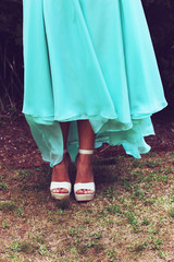 Portrait of the feet of a young woman wearing a formal dress and high heels, dressed and ready for her school formal