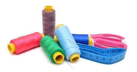 thread and scissors on white