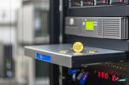 Bitcoin, litecoin ethereum on PC in the server room, golden coins, souvenirs coins, copy space. Business concept: cryptocurrency fever