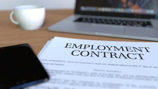 Copy of employment contract on the desk