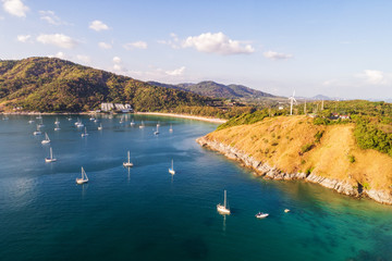 Aerial shot of beauty bay nature landscape with island, yachts and clear sea with turquoise water on Phuket. Drone photo.