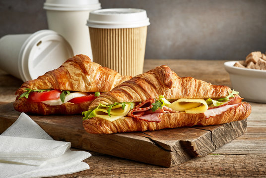 croissant sandwiches and coffee cups