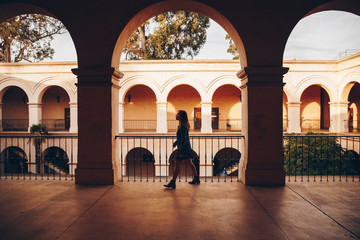 Woman Walking Through Golden Arches