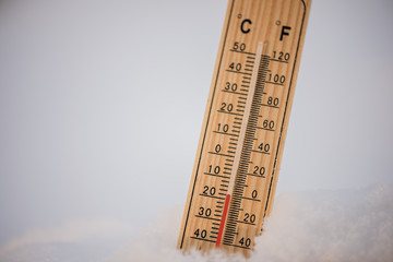 Thermometer in a snow showing freezing low below zero  sub zero temperatures