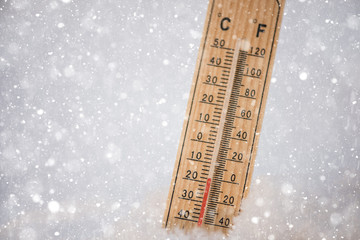 Thermometer in a snow showing freezing low below zero  sub zero temperatures